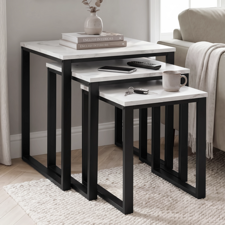 [White Marble] Stackora nest of 3 tables used as side and coffee tables in living room with books, mug, remote, and keys