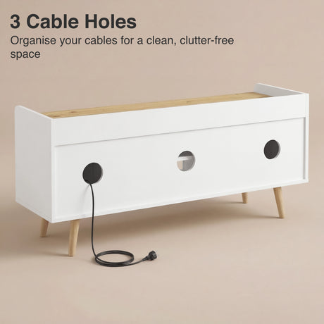 Rear panel of white and oak media unit with cable holes aligned for organised wire routing and clean setup