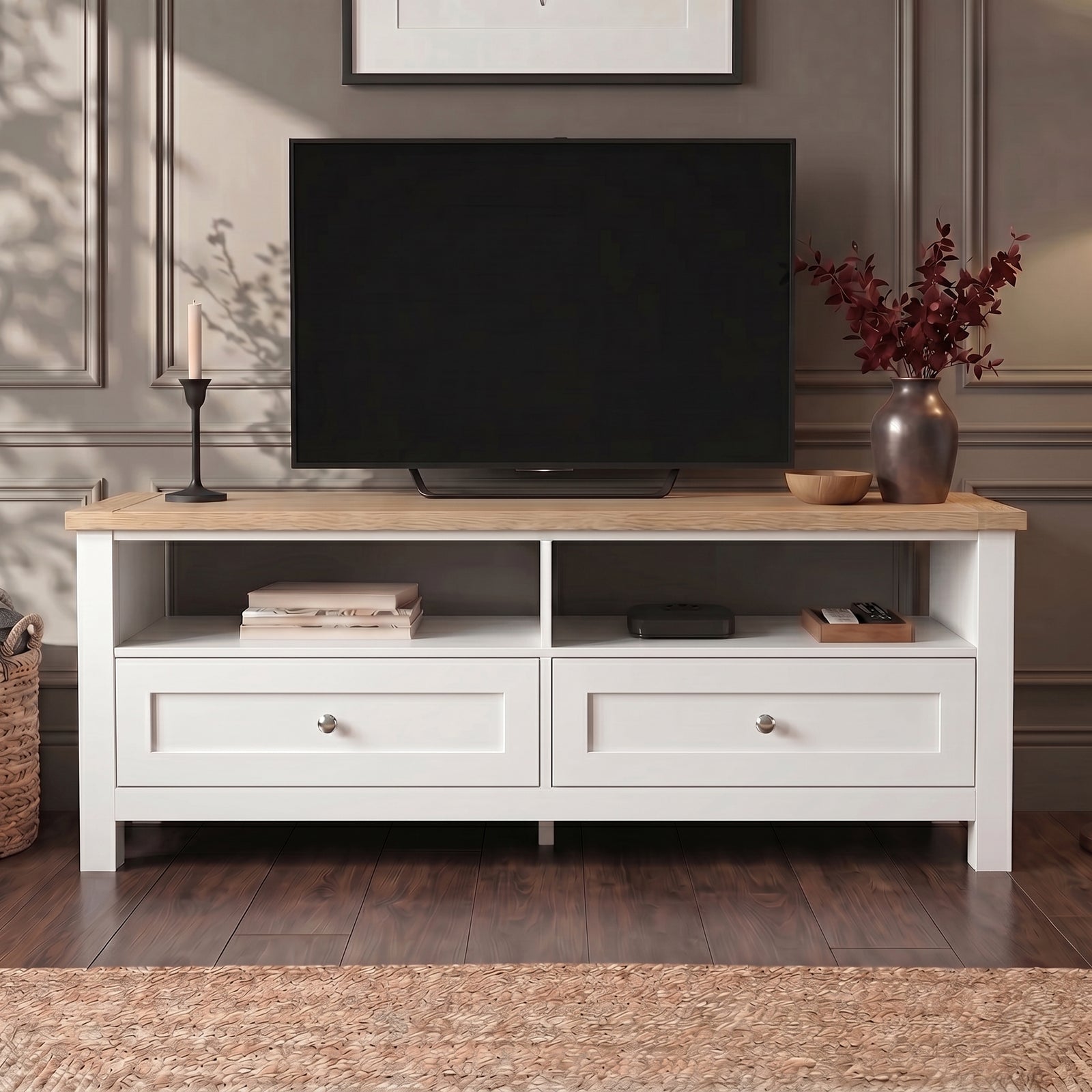 [White] Oskara White Painted TV Unit with Storage shown front-on in a grey panelled room with a TV, open shelves holding books and a media box, and two shaker-style drawers below