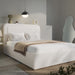 Modern bedroom with a white upholstered bed and decorative pillows.