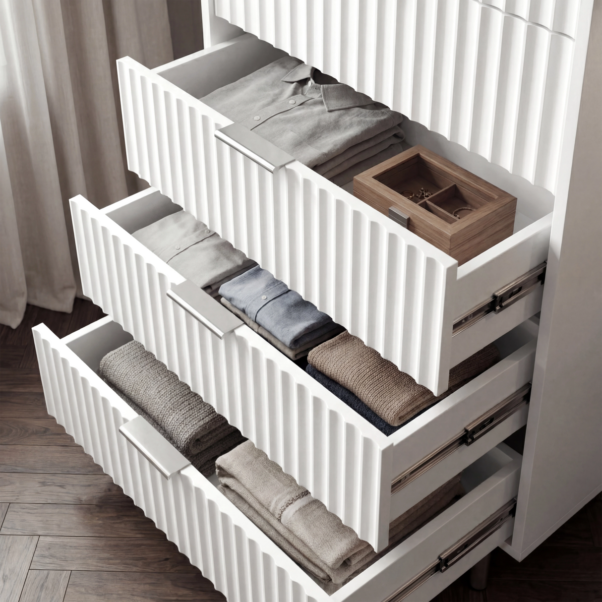 White flutrina chest of drawers with multiple drawers extended to display internal storage capacity