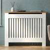 [Medium | White] Radiator Cover front view with oak top shelf holding a diffuser, tray, and book against a teal wall