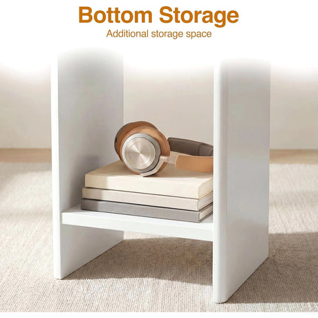 [White] Small Round Side Table with Shelf Living Room close-up of lower storage shelf between panel legs holding books and headphones on beige rug