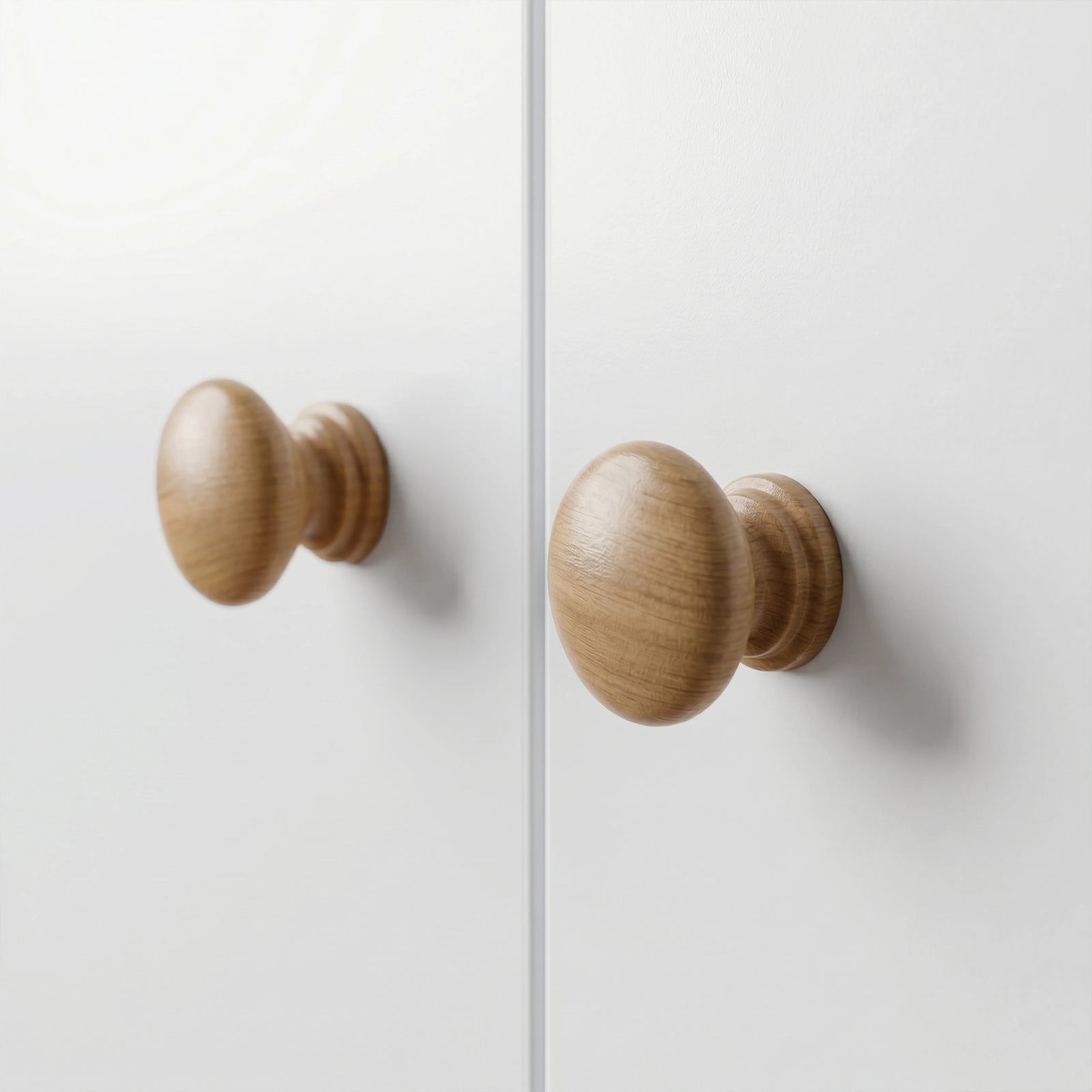 [White] Selby wardrobe close-up of two round natural wood door knobs on white flat door panels