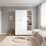 [White]  Children's room with a white wardrobe, teddy bear, and toys on a light gray wall.