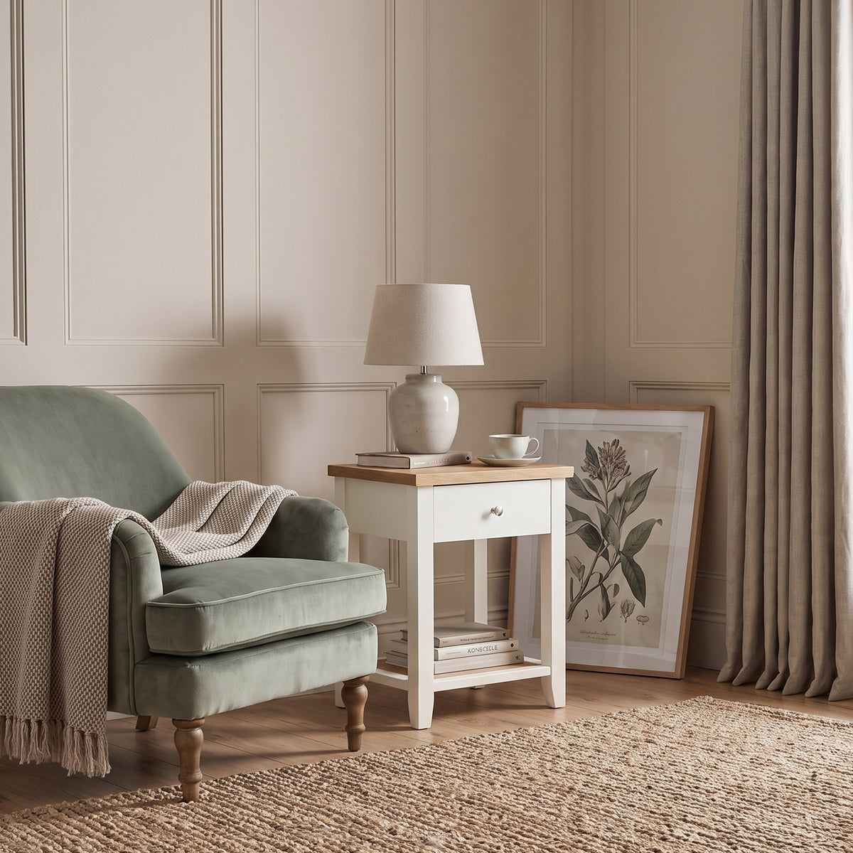 [White] White Shaker Bedside Table placed next to an armchair in a cozy reading corner setup.