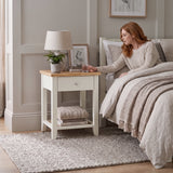 [White] Lifestyle view of the White Shaker Bedside Table styled beside a modern upholstered bed.