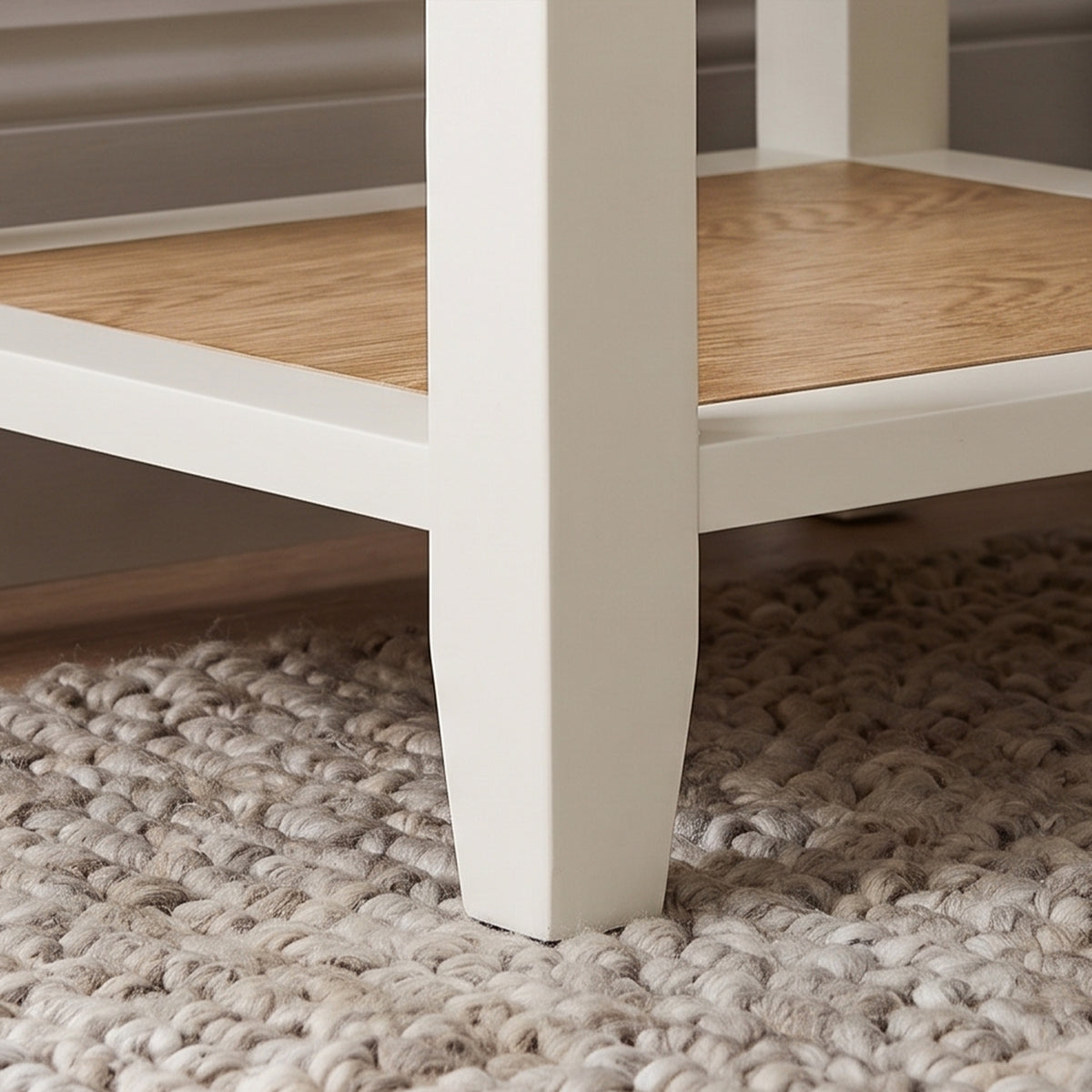 [White] Close-up view of the tapered white leg and lower shelf joinery on the Shaker Bedside Table.