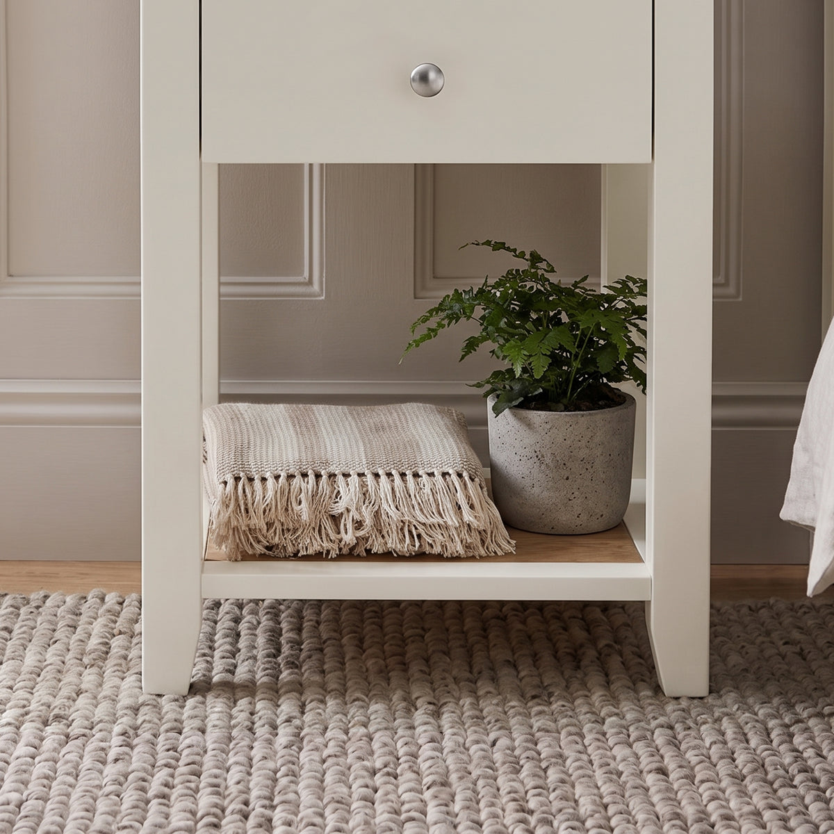 [White] Close-up detail of the polished silver round knob on the White Shaker Bedside Table drawer.