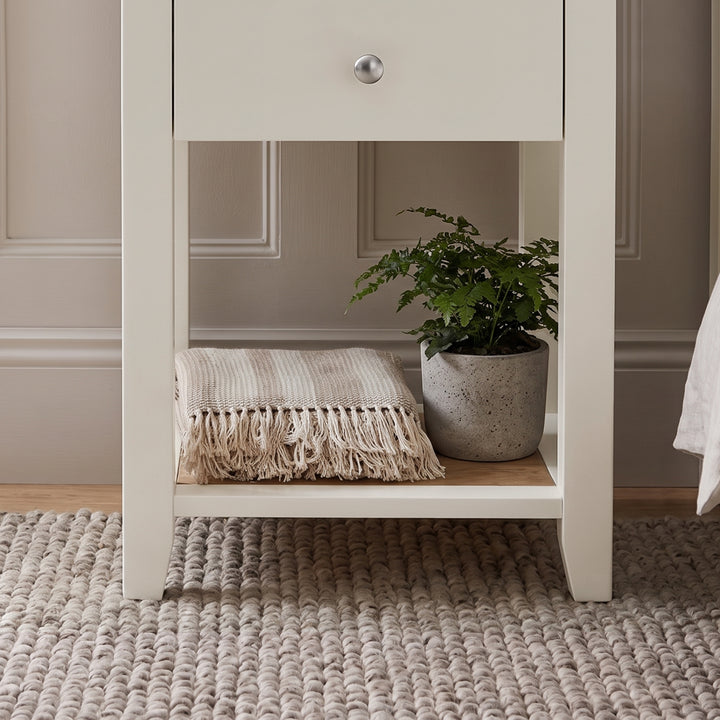 [White] Close-up detail of the polished silver round knob on the White Shaker Bedside Table drawer.