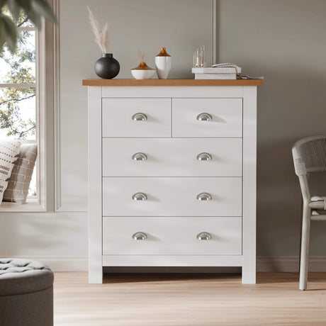 [White] 5 drawer chest with 2 small and 3 large drawers in styled bedroom