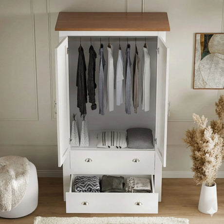 [White] shaker double wardrobe with open doors showing hanging rail, top oak and 2 drawers below, placed beside a flower pot