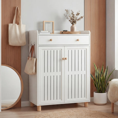 Compact entryway white shoe storage with a slatted-pattern door and a top drawer for small items