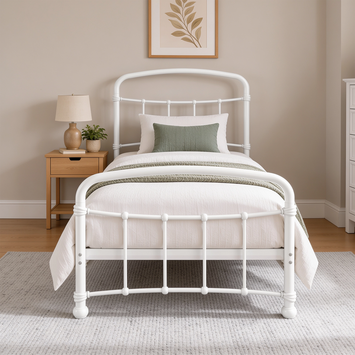 [White | Single] Front view showing curved headboard and footboard, cushion, throw, bedside table, lamp, and leaf art.
