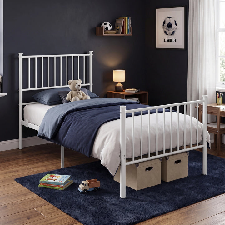 [White | Single] Bedroom scene showing metal bed, teddy bear, navy bedding, storage boxes, books, toy truck, and lamp.