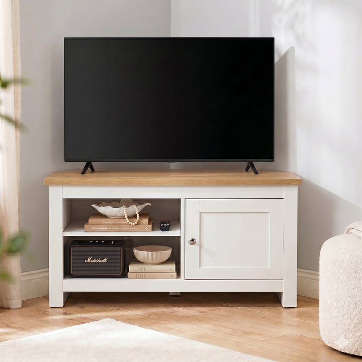 [White] Tavero White Corner TV Unit with Storage front view positioned in room corner with oak top, open shelving, shaker door and brushed nickel knob
