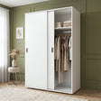 [White] Torvek large sliding wardrobe side angled view in bright neutral bedroom with sheer curtains