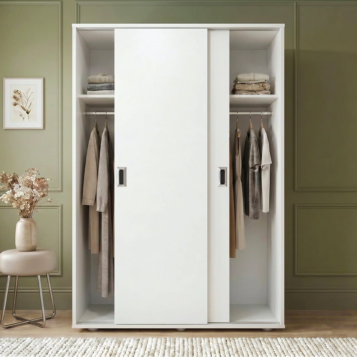 [White] White wardrobe with clothes in a room with green walls and a small table with flowers.