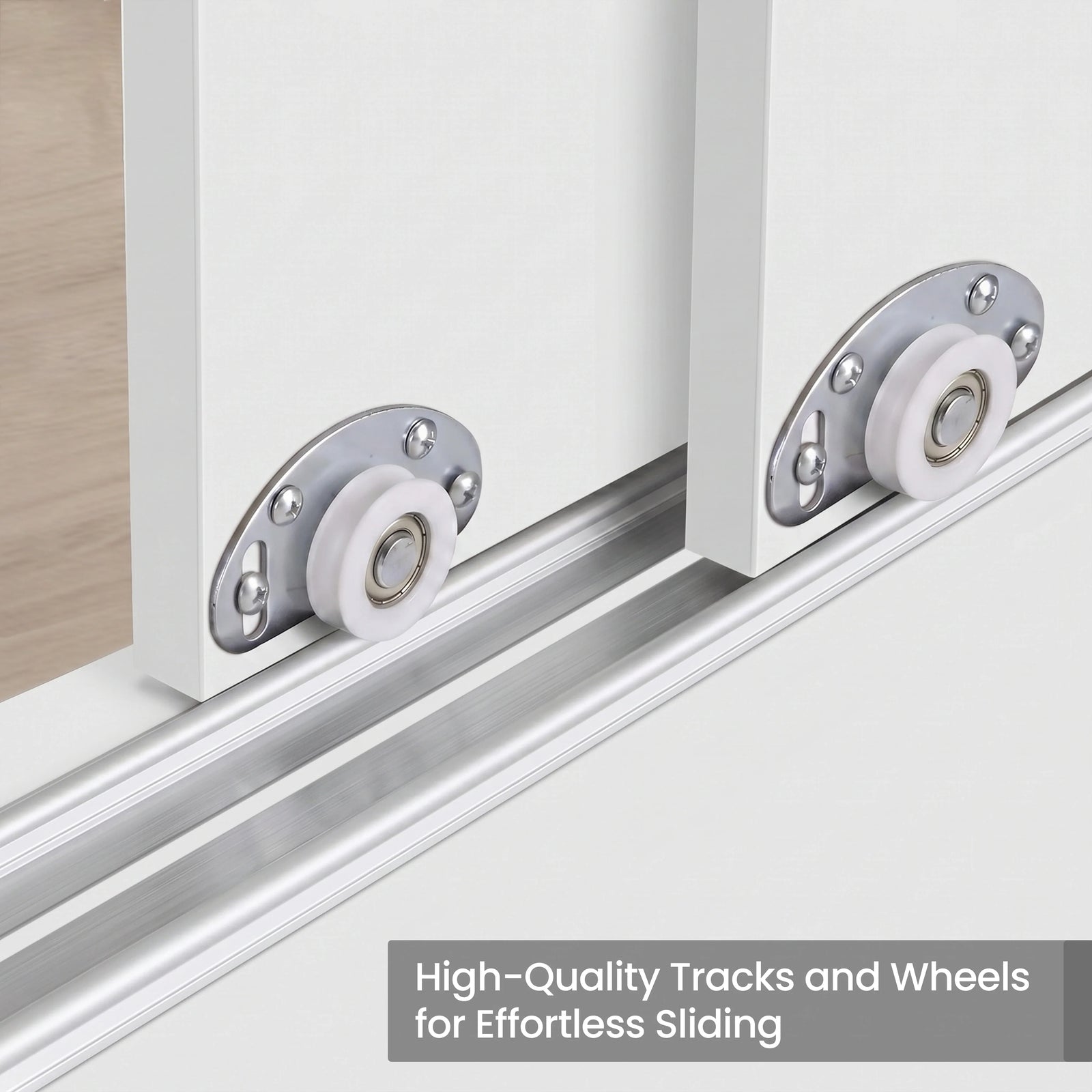 [White] Torvek wardrobe close-up of white sliding door roller wheels on aluminium bottom track rail