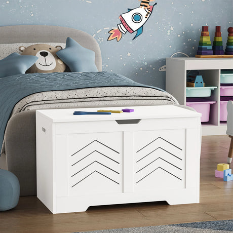 White storage bench with geometric design in a child's bedroom with toys and a teddy bear.