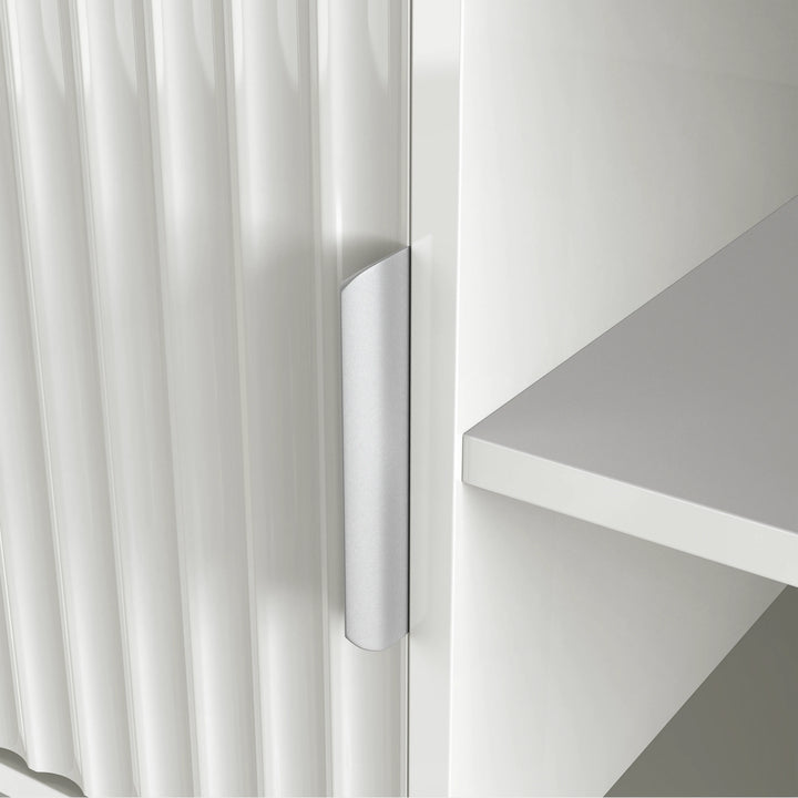 [White] Handle detail on white Flutrina TV unit door, vertical fluted grooves clearly visible across the door surface.