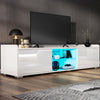 Modern white TV stand with a television mounted on a gray wall.