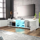 Modern living room with a white entertainment console, TV, and decorative items.