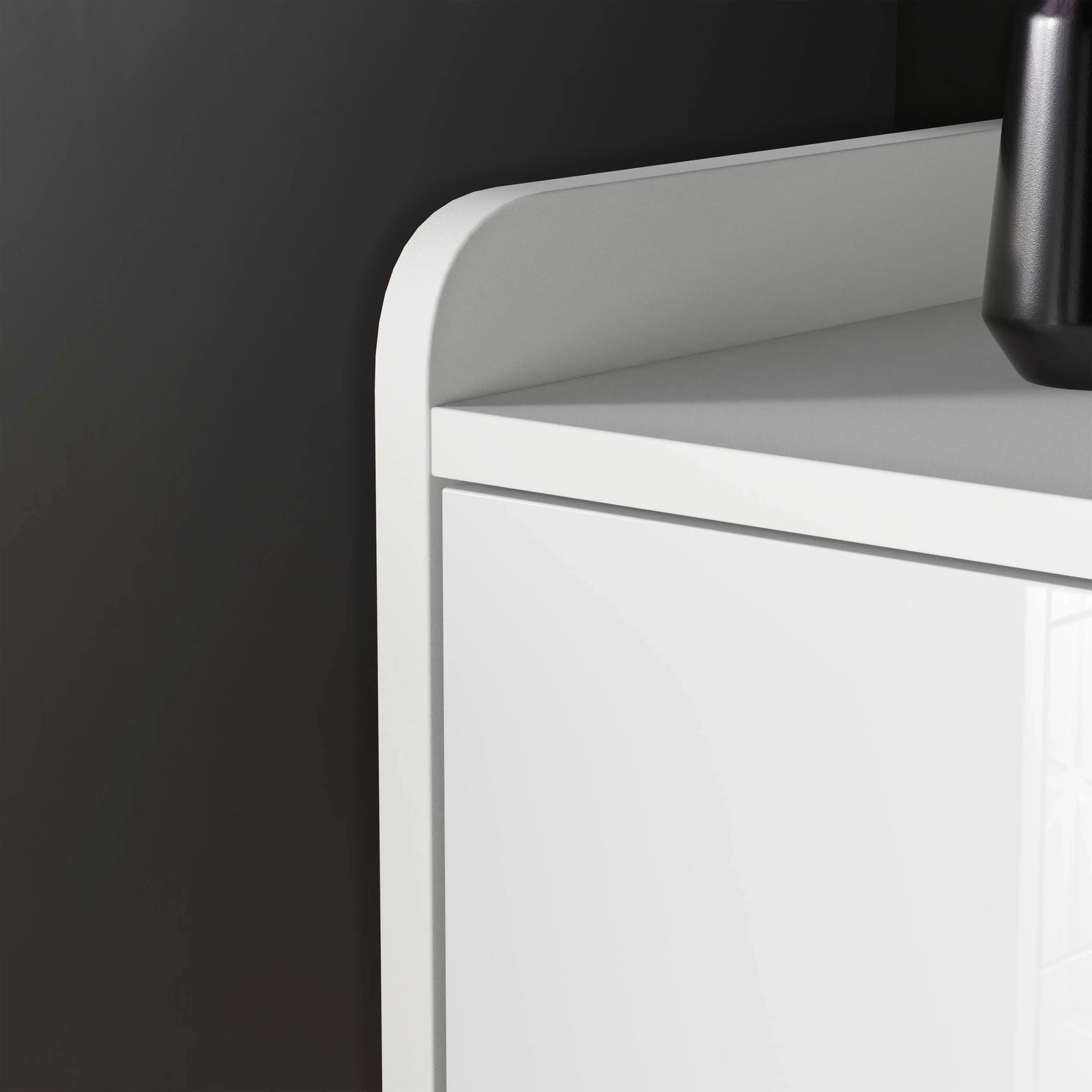 [White] edge view white TV unit highlighting curved tray-style top and gloss flap door below