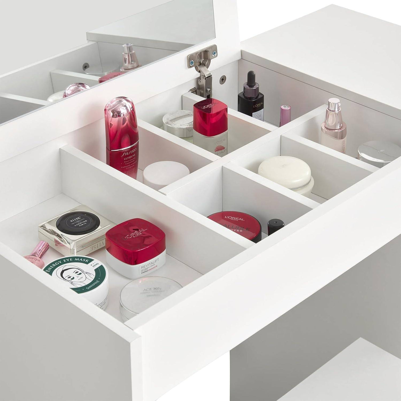 Small dressing table with flip-up mirror and organized storage compartments for makeup and skincare, includes matching stool for bedroom vanity setup.