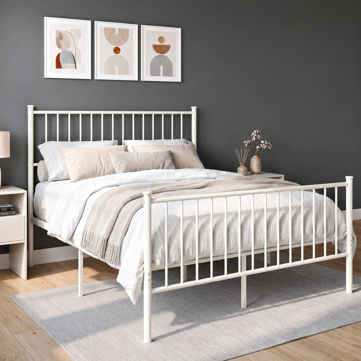[White | Double] Angled view of white metal bed with bedding, tall bar headboard, matching footboard and centre support legs.