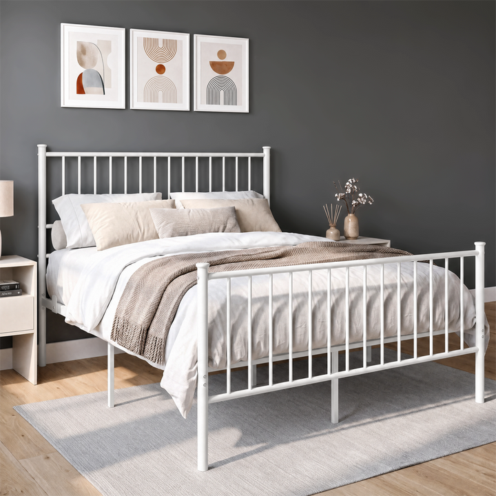 [White | Double] Angled view of white metal bed with bedding, tall bar headboard, matching footboard and centre support legs.