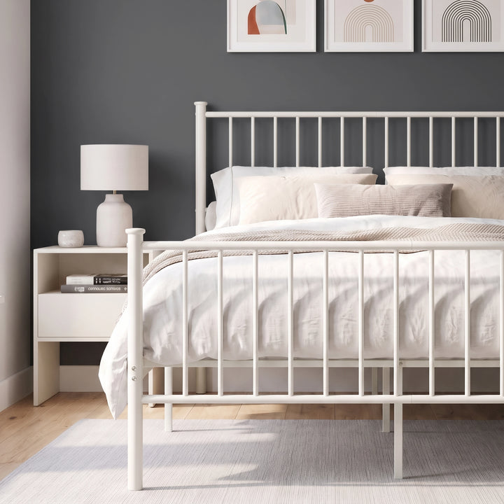 [White | Double] Metal bed front close-up view of white bar footboard, tall headboard, neutral bedding & centre support legs.