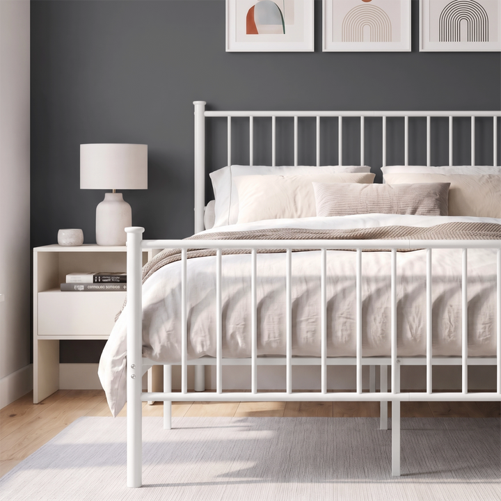 [White | Double] Metal bed front close-up view of white bar footboard, tall headboard, neutral bedding & centre support legs.