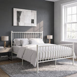 [White | King] Angled view of metal bed with white bedding, bar ends, centre legs, bedside lamps, wall art and bright window.
