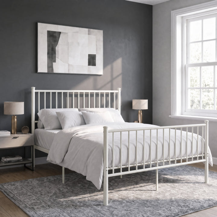 [White | King] Angled view of metal bed with white bedding, bar ends, centre legs, bedside lamps, wall art and bright window.