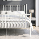 [White | King] Metal bed front close-up view of bar headboard and footboard, white bedding, centre legs, bedside table & lamp