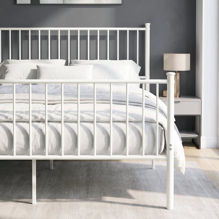 [White | King] Metal bed front close-up view of bar headboard and footboard, white bedding, centre legs, bedside table & lamp
