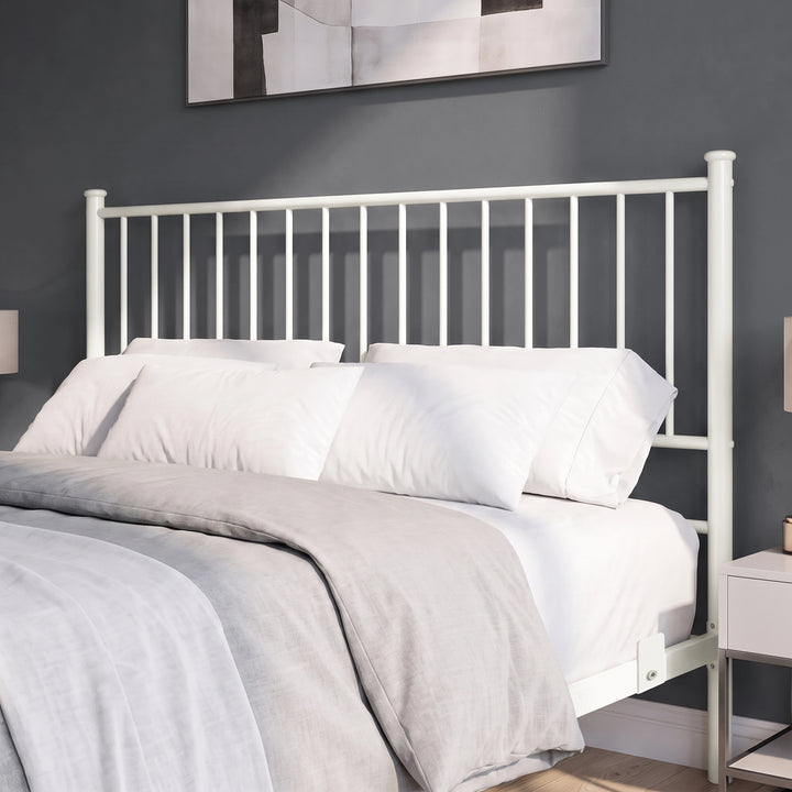 [White | King] Bed close-up view of tall white bar headboard, white pillows, grey bedding, side rail & mattress support tab.