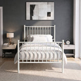[White | Single] Front view of vertical iron bed with white-grey bedding, bar ends, centre leg, wall art, lamp & alarm clock.