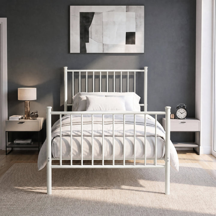 [White | Single] Front view of vertical iron bed with white-grey bedding, bar ends, centre leg, wall art, lamp & alarm clock.