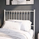 [White | Single] Metal bed close-up view of tall bar headboard with white pillows against a grey wall with abstract art.