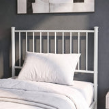 [White | Single] Metal bed close-up view of tall bar headboard with white pillows against a grey wall with abstract art.