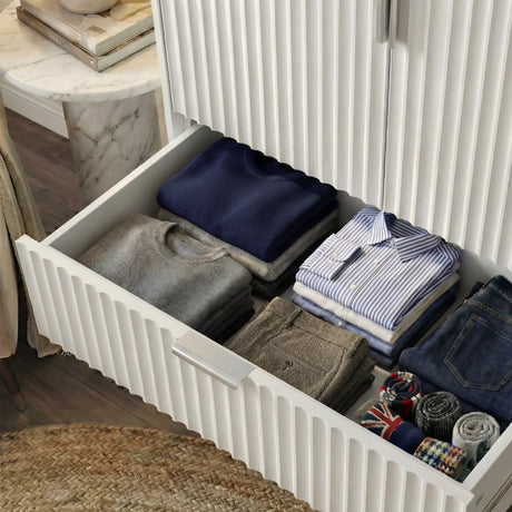 White wardrobe drawer interior with a folded stack of clothing storage and a smooth slide mechanism