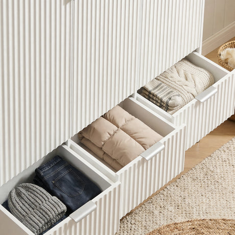 [White]  wardrobe three drawer storage sections showing internal organisation and a stack of clothes