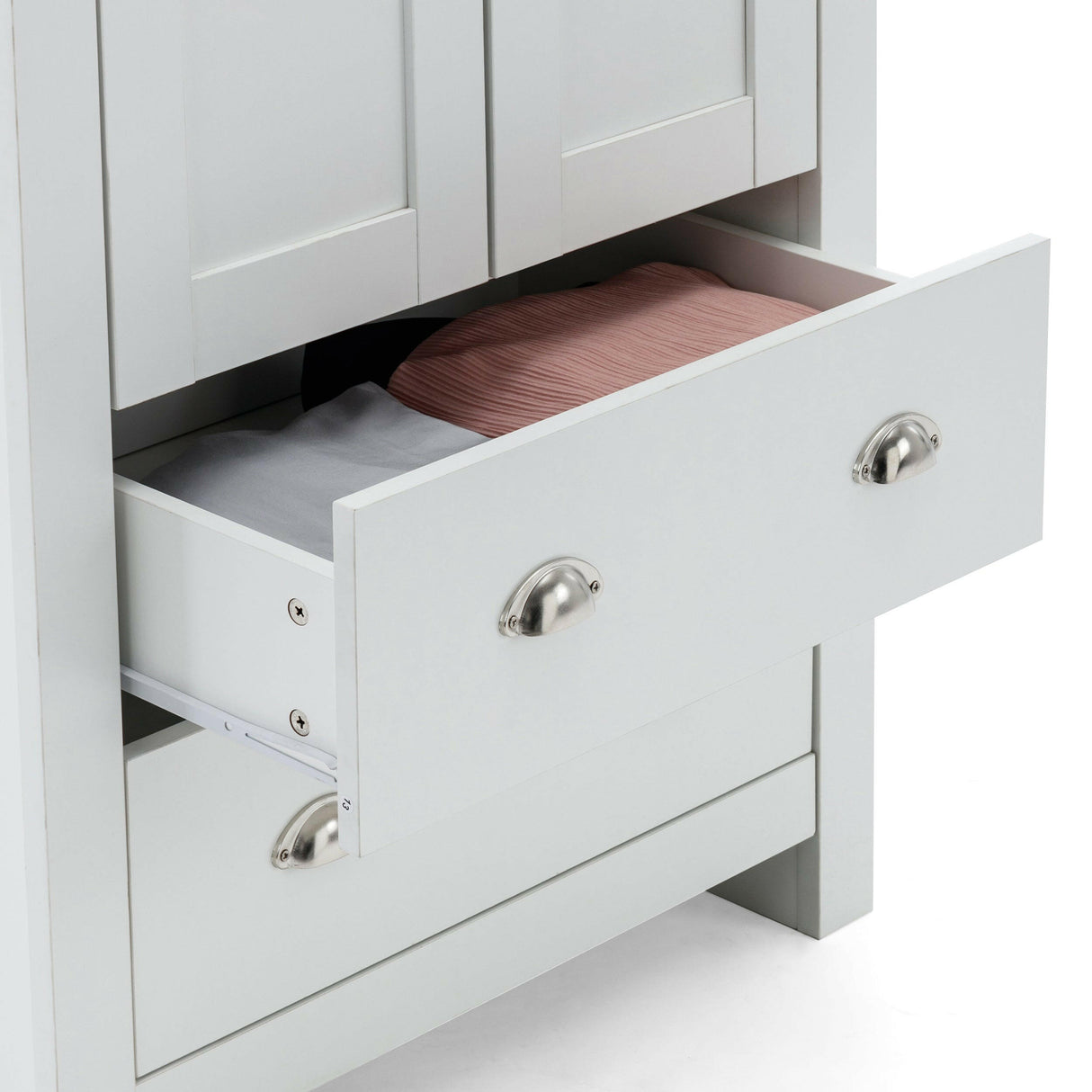 White wardrobe drawer partially open, showing folded pink and grey garments inside.