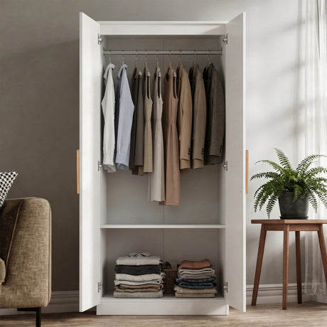 [White] Open wardrobe with clothes hanging and folded inside, in a room with a plant and chair.