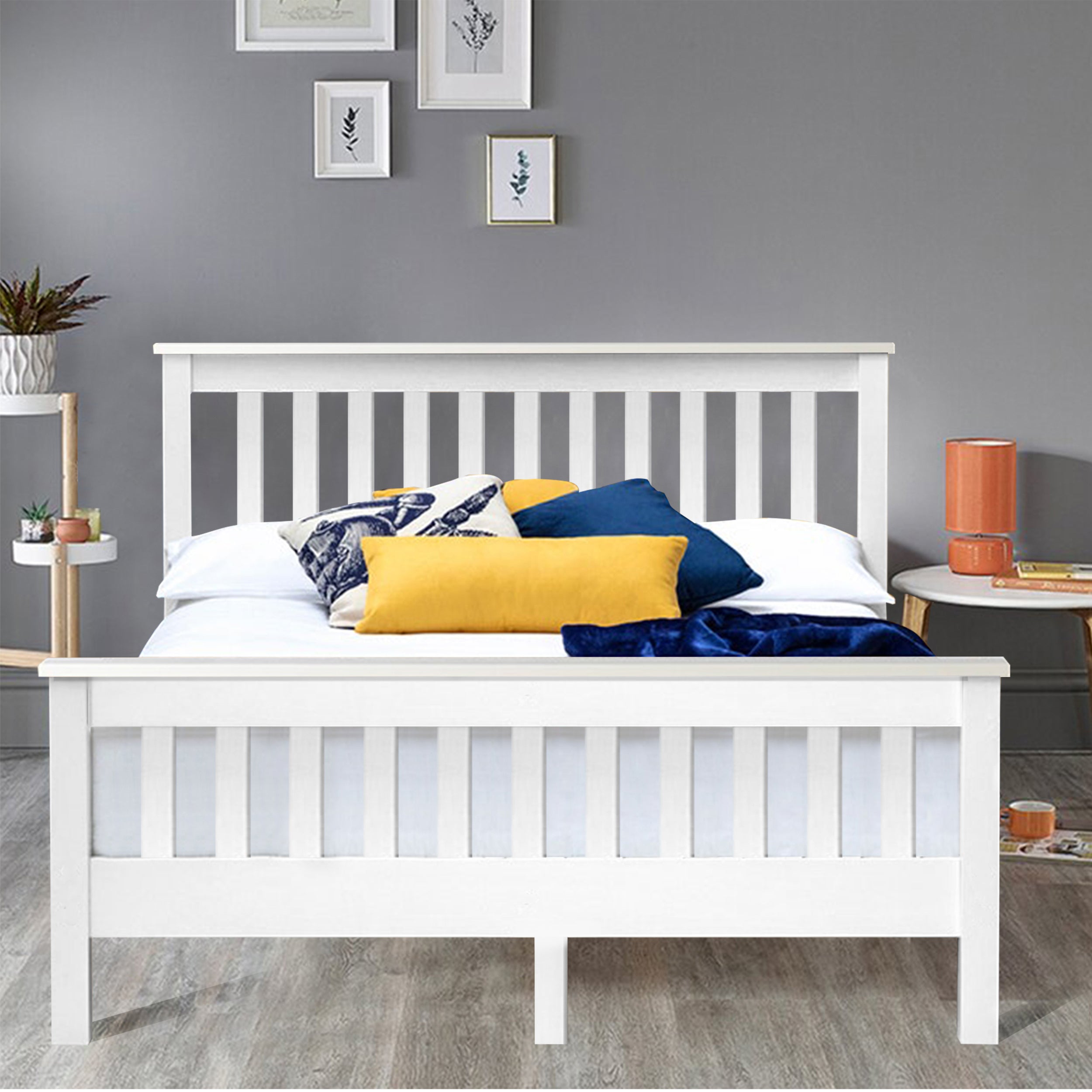 Stylish white wooden double bed frame with a slatted headboard and cozy colorful bedding.