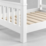 [White] Close-up of bunk bed corner showing slatted end panel, side rail, wooden slats and square leg
