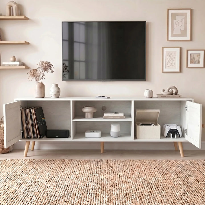 [White] Wovena Rattan TV Unit with both doors open showing vinyl records, soundbar, Apple TV, smart speaker, fabric box, and game controllers