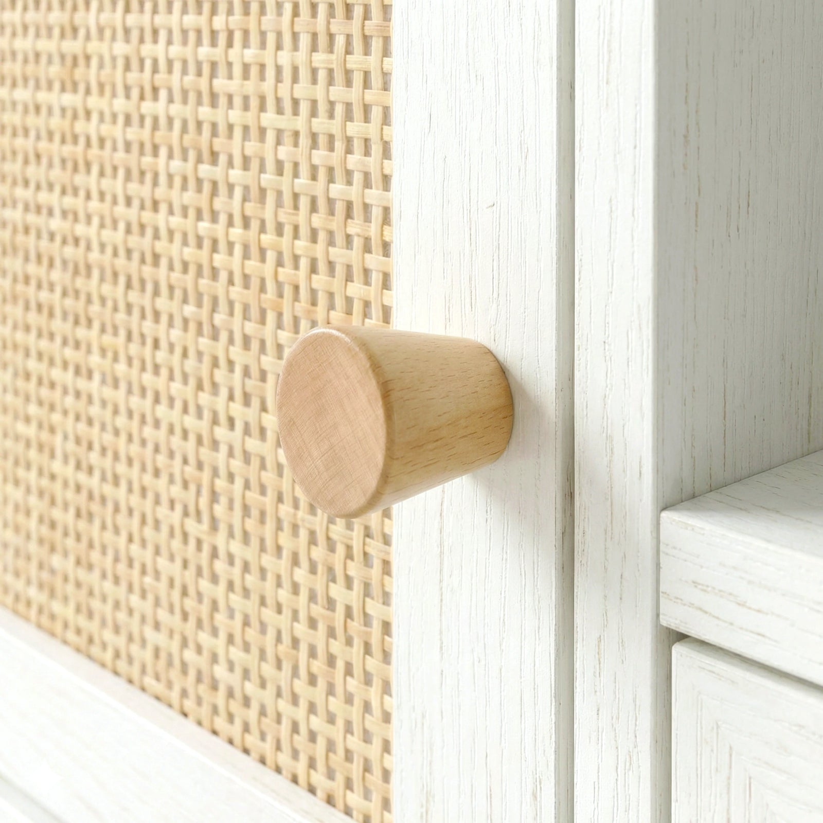 [White] Wovena Rattan TV Unit close-up of woven cane panel, natural wooden knob, and white wood-grain finish on the door